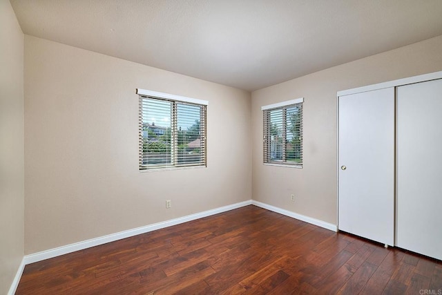 932 Alyssum Rd, Carlsbad, CA 92011 - unfurnished bedroom featuring dark wood-type flooring and a closet