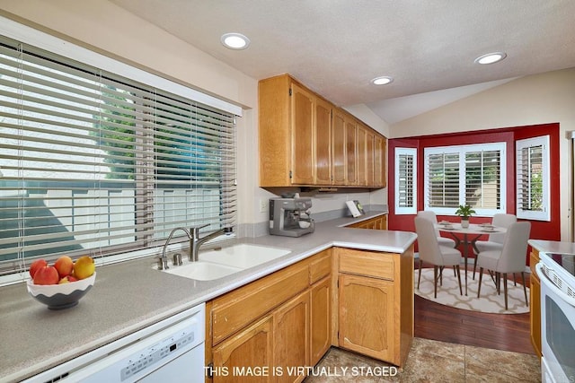 932 Alyssum Rd, Carlsbad, CA 92011 - kitchen featuring white appliances, vaulted ceiling, light countertops, recessed lighting, and a peninsula
