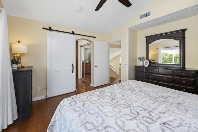 647 Boysenberry Way, Oceanside, CA 92057 - bedroom with vaulted ceiling, wood finished floors, a barn door, and a ceiling fan
