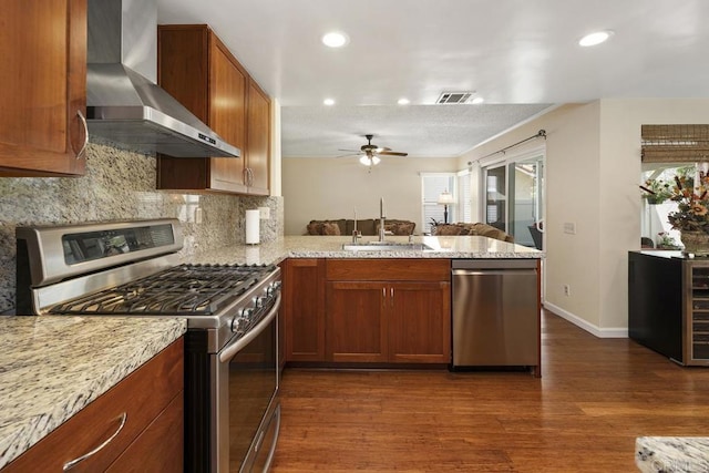 647 Boysenberry Way, Oceanside, CA 92057 - kitchen with stainless steel appliances, wall chimney range hood, dark wood-style flooring, ceiling fan, and a peninsula