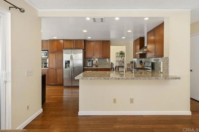 647 Boysenberry Way, Oceanside, CA 92057 - kitchen featuring appliances with stainless steel finishes, a peninsula, decorative backsplash, brown cabinets, and recessed lighting