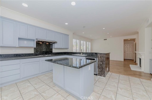 2768 Somerset Pl, Rowland Heights, CA 91748 - kitchen featuring stainless steel appliances, a peninsula, under cabinet range hood, a center island, and light tile patterned floors
