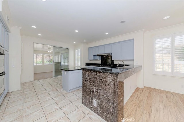 2768 Somerset Pl, Rowland Heights, CA 91748 - kitchen with crown molding, a peninsula, recessed lighting, under cabinet range hood, and dark stone countertops