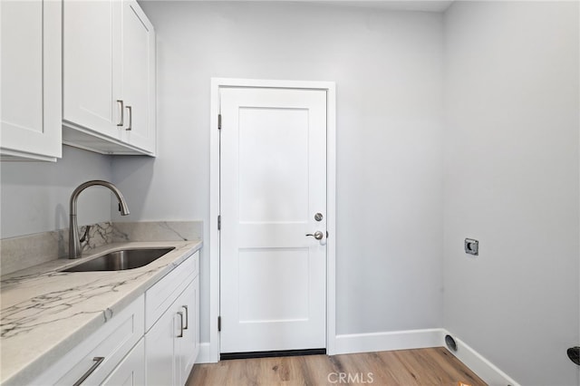 11128 Stamy Rd, Whittier, CA 90604 - washroom featuring cabinet space, light wood-type flooring, and electric dryer hookup