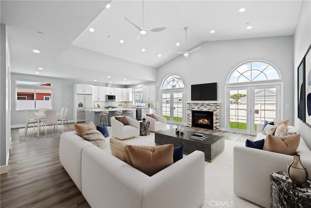 11128 Stamy Rd, Whittier, CA 90604 - living area with recessed lighting, wood finished floors, high vaulted ceiling, a tile fireplace, and a ceiling fan