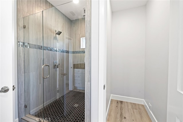 11128 Stamy Rd, Whittier, CA 90604 - bathroom featuring a stall shower and wood finished floors