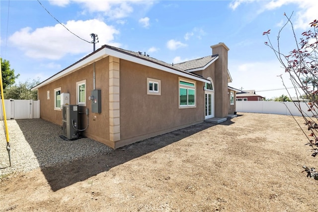 11128 Stamy Rd, Whittier, CA 90604 - view of home's exterior featuring a fenced backyard, a chimney, and stucco siding
