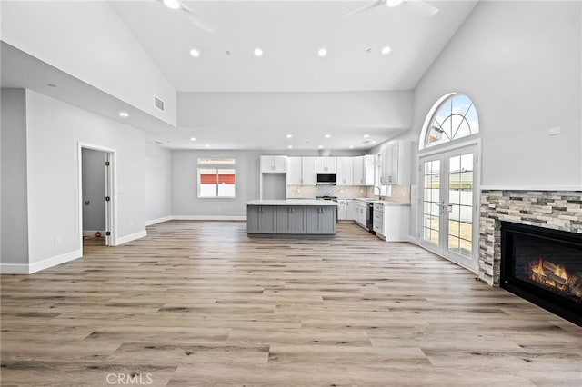 11128 Stamy Rd, Whittier, CA 90604 - unfurnished living room with high vaulted ceiling, french doors, recessed lighting, light wood-type flooring, and healthy amount of natural light