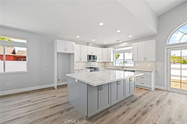 11128 Stamy Rd, Whittier, CA 90604 - kitchen with stainless steel appliances, gray cabinetry, a kitchen island, white cabinetry, and light wood finished floors