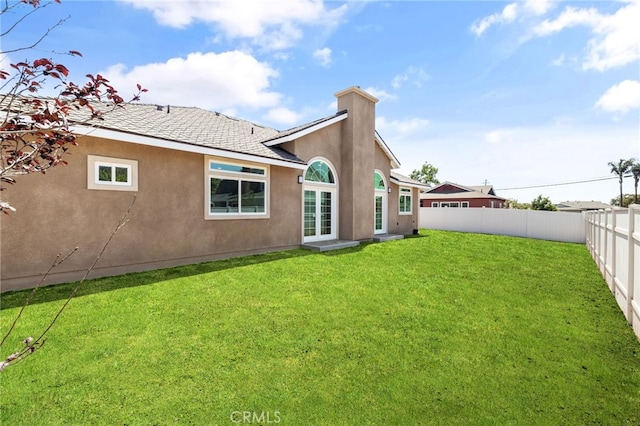 11128 Stamy Rd, Whittier, CA 90604 - rear view of house featuring stucco siding, a fenced backyard, and a chimney