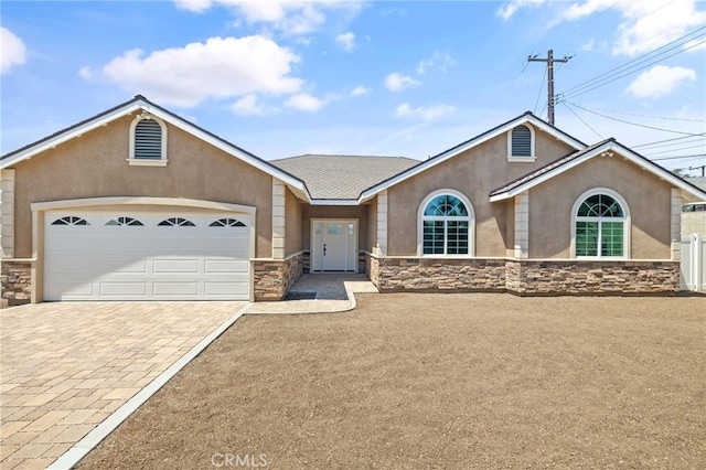 11128 Stamy Rd, Whittier, CA 90604 - ranch-style house with stone siding, stucco siding, driveway, and a garage