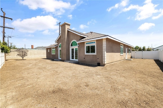 11128 Stamy Rd, Whittier, CA 90604 - back of house featuring a fenced backyard, stucco siding, and a chimney