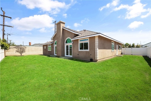 11128 Stamy Rd, Whittier, CA 90604 - rear view of house featuring a fenced backyard, a chimney, and stucco siding