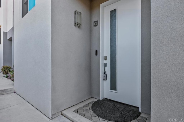 7570 Gibraltar St Unit 101, Carlsbad, CA 92009 - doorway to property with stucco siding
