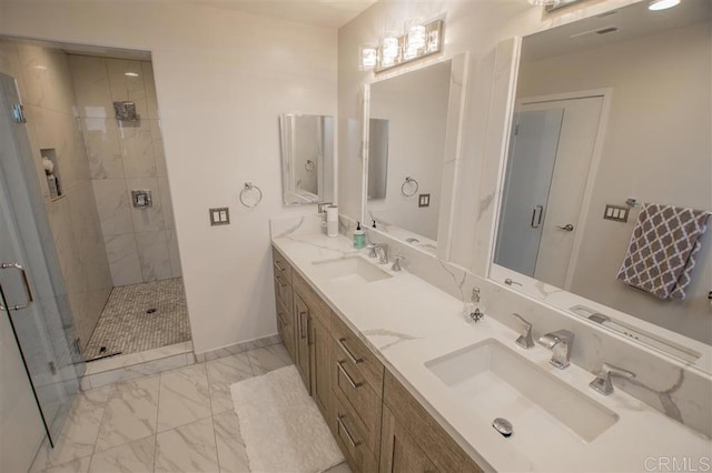 7570 Gibraltar St Unit 101, Carlsbad, CA 92009 - bathroom featuring marble look tiles, a shower stall, and double vanity