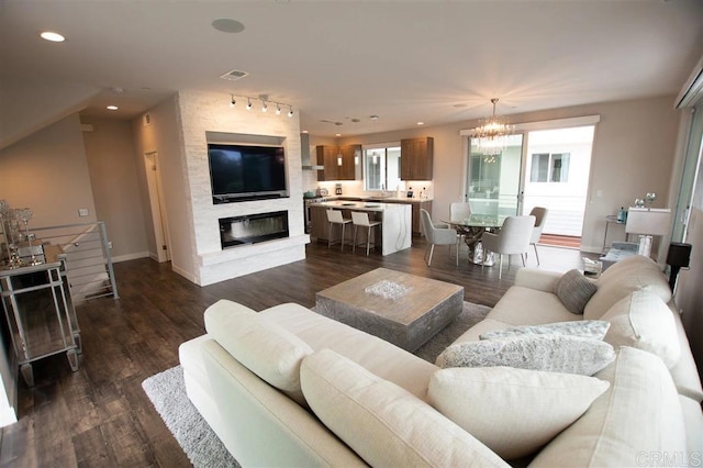 7570 Gibraltar St Unit 101, Carlsbad, CA 92009 - living room with a chandelier, plenty of natural light, dark wood-type flooring, and recessed lighting