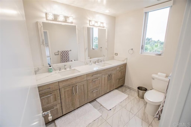 7570 Gibraltar St Unit 101, Carlsbad, CA 92009 - full bathroom with double vanity, healthy amount of natural light, and marble look tiles
