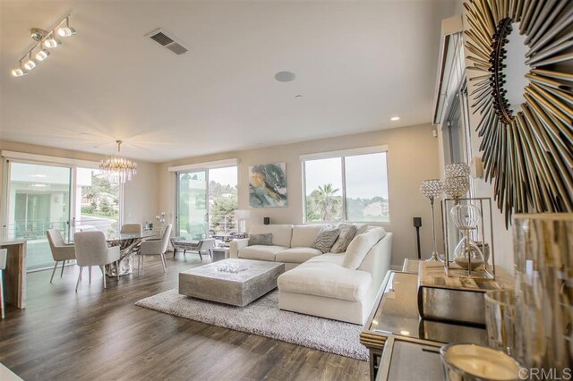 7570 Gibraltar St Unit 101, Carlsbad, CA 92009 - living area featuring wood finished floors, a chandelier, track lighting, and recessed lighting