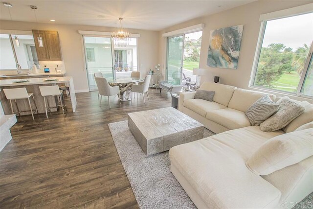 7570 Gibraltar St Unit 101, Carlsbad, CA 92009 - living room featuring recessed lighting, dark wood-style flooring, and a chandelier