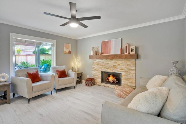 5232 Palmera Dr, Oceanside, CA 92056 - living room featuring ornamental molding, a ceiling fan, a stone fireplace, and light wood-type flooring