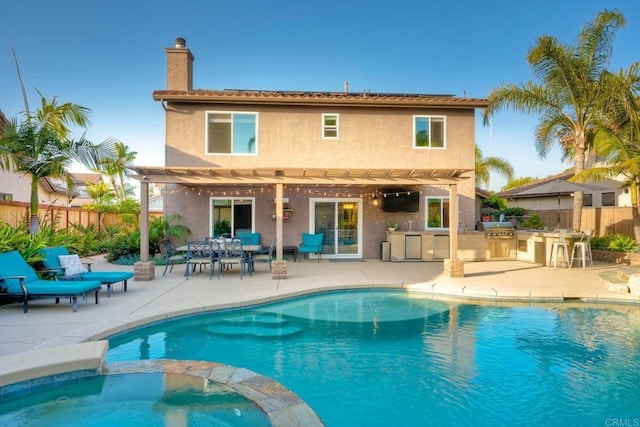 5232 Palmera Dr, Oceanside, CA 92056 - back of house with an outdoor kitchen, a pergola, stucco siding, a chimney, and a pool with connected hot tub
