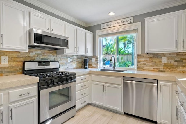 5232 Palmera Dr, Oceanside, CA 92056 - kitchen featuring stainless steel appliances, white cabinetry, light countertops, crown molding, and recessed lighting