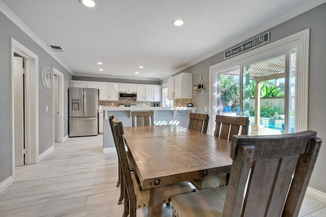 5232 Palmera Dr, Oceanside, CA 92056 - dining room featuring ornamental molding, recessed lighting, and light wood finished floors