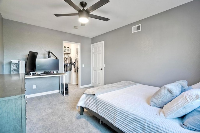 5232 Palmera Dr, Oceanside, CA 92056 - bedroom with light colored carpet, an office area, a spacious closet, ceiling fan, and a closet