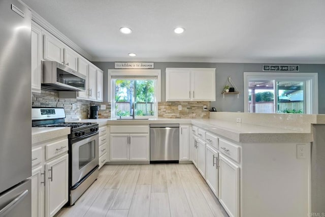 5232 Palmera Dr, Oceanside, CA 92056 - kitchen featuring stainless steel appliances, ornamental molding, a peninsula, light countertops, and recessed lighting
