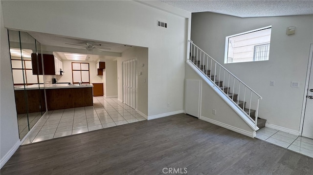 44460 15th St E Unit 13, Lancaster, CA 93535 - staircase with wood finished floors, a ceiling fan, and a textured ceiling