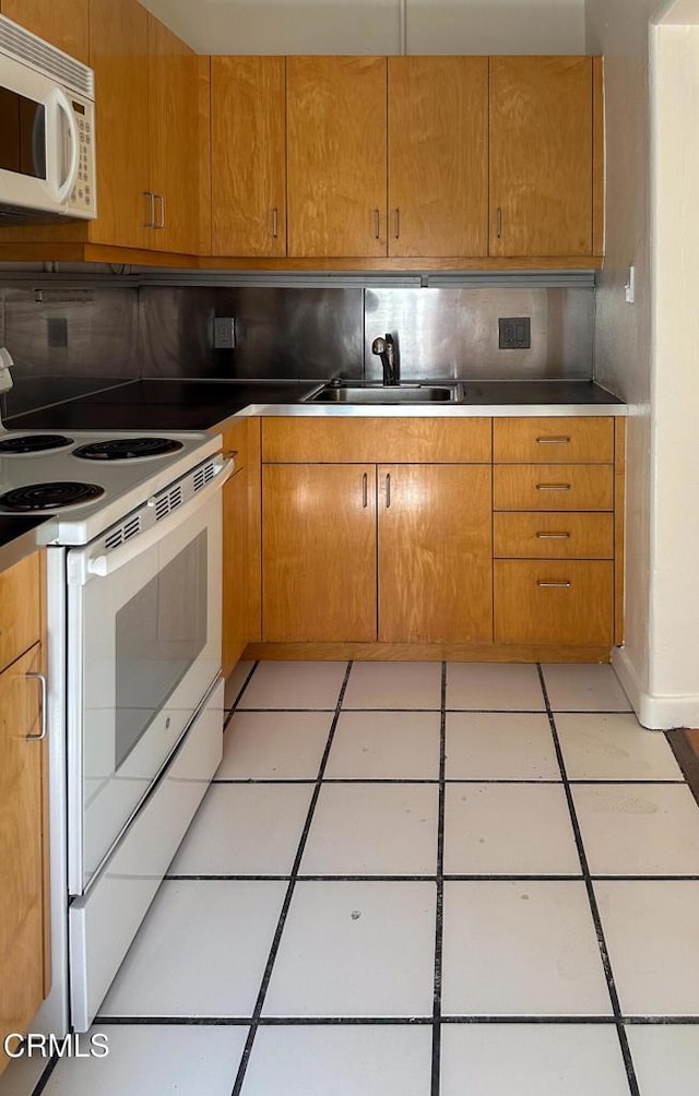 980 N Hoover St, Los Angeles, CA 90029 - kitchen featuring white appliances, tasteful backsplash, light tile patterned floors, and brown cabinets
