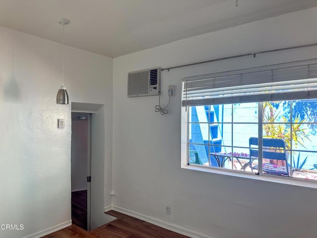 980 N Hoover St, Los Angeles, CA 90029 - unfurnished room featuring a wall unit AC and wood finished floors