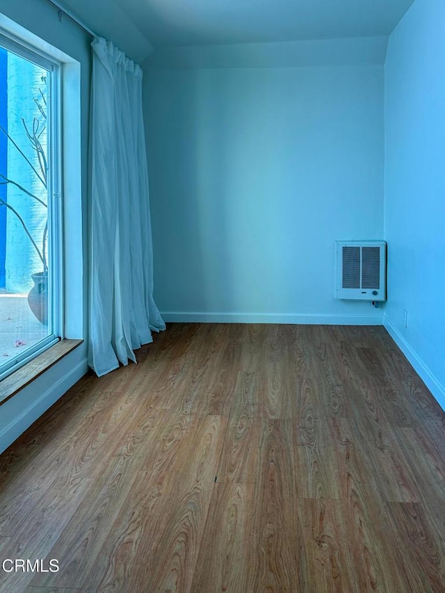 980 N Hoover St, Los Angeles, CA 90029 - empty room featuring wood finished floors and heating unit