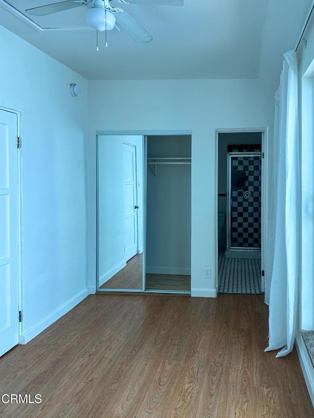 980 N Hoover St, Los Angeles, CA 90029 - unfurnished bedroom with wood finished floors and a closet