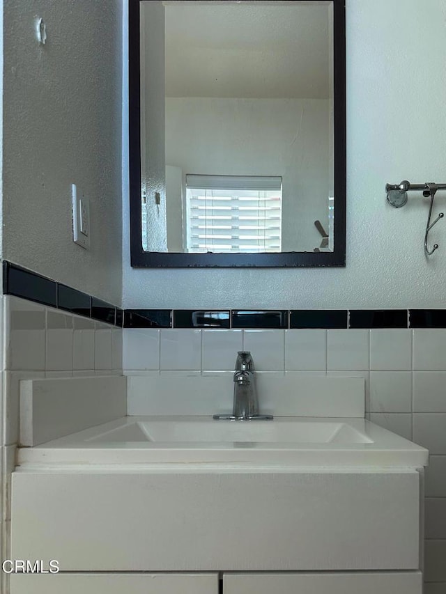 980 N Hoover St, Los Angeles, CA 90029 - bathroom with tile walls, a textured wall, and vanity