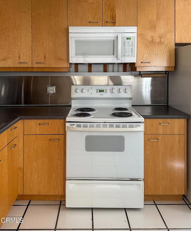 980 N Hoover St, Los Angeles, CA 90029 - kitchen with white appliances, light tile patterned flooring, and dark countertops