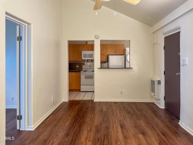 980 N Hoover St, Los Angeles, CA 90029 - unfurnished living room featuring lofted ceiling, heating unit, wood finished floors, ceiling fan, and washer / dryer