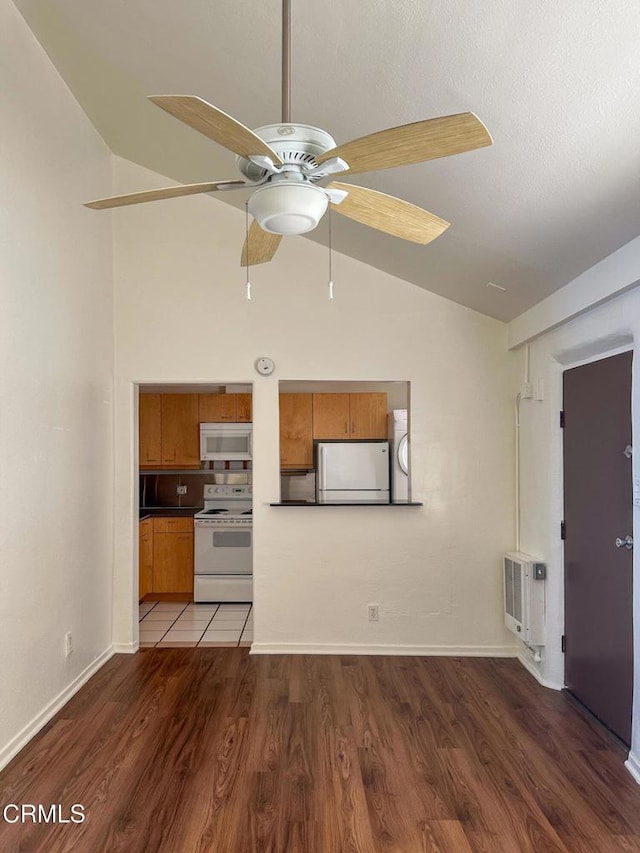 980 N Hoover St, Los Angeles, CA 90029 - unfurnished living room featuring heating unit, a ceiling fan, wood finished floors, and high vaulted ceiling