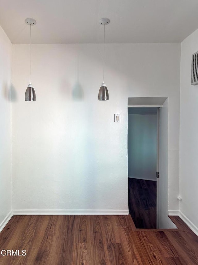 980 N Hoover St, Los Angeles, CA 90029 - unfurnished dining area with wood finished floors and baseboards