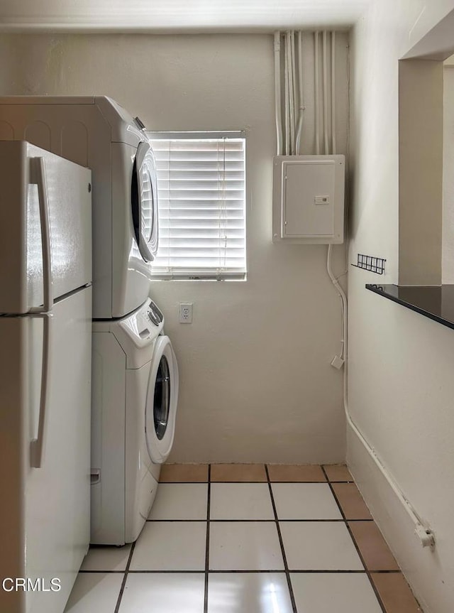 980 N Hoover St, Los Angeles, CA 90029 - laundry area with stacked washer / drying machine, electric panel, and light tile patterned flooring