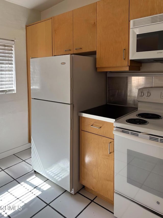 980 N Hoover St, Los Angeles, CA 90029 - kitchen featuring white appliances and light tile patterned flooring
