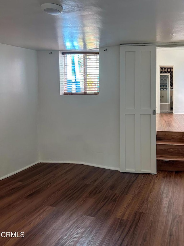 980 N Hoover St, Los Angeles, CA 90029 - spare room featuring dark wood-style flooring and baseboards
