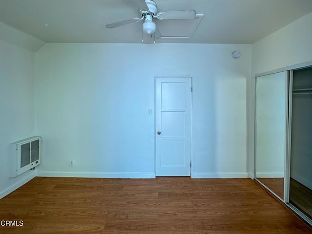 980 N Hoover St, Los Angeles, CA 90029 - unfurnished bedroom featuring heating unit, wood finished floors, a closet, vaulted ceiling, and a ceiling fan