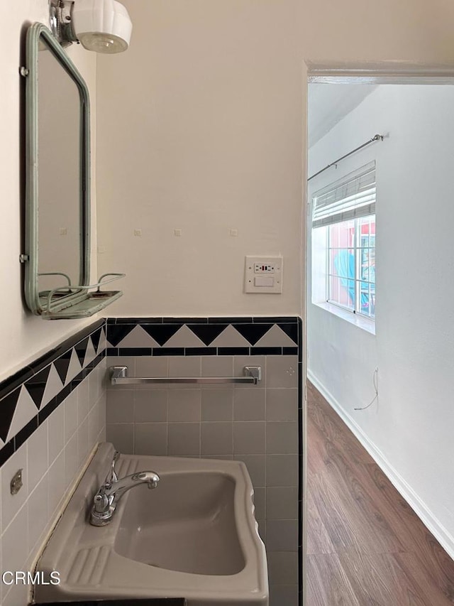 980 N Hoover St, Los Angeles, CA 90029 - bathroom featuring tile walls, wood finished floors, and wainscoting