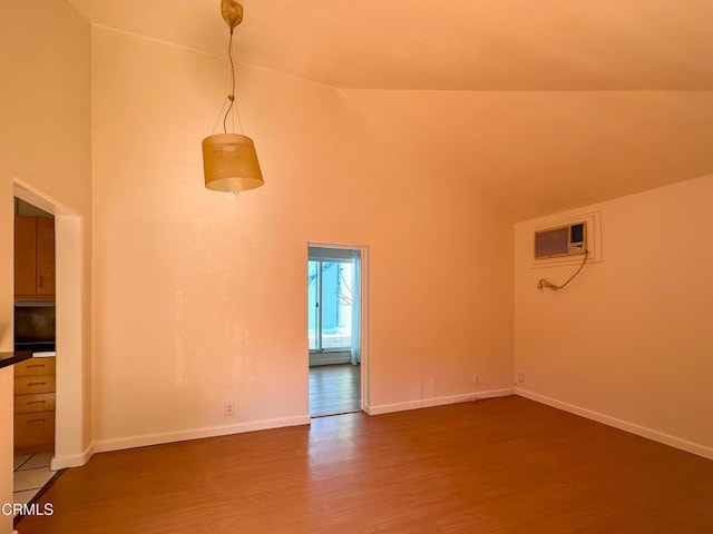 980 N Hoover St, Los Angeles, CA 90029 - unfurnished living room with dark wood finished floors, high vaulted ceiling, and an AC wall unit