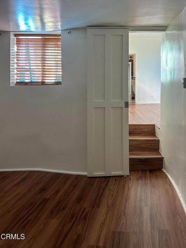 980 N Hoover St, Los Angeles, CA 90029 - corridor with dark wood-style flooring and baseboards