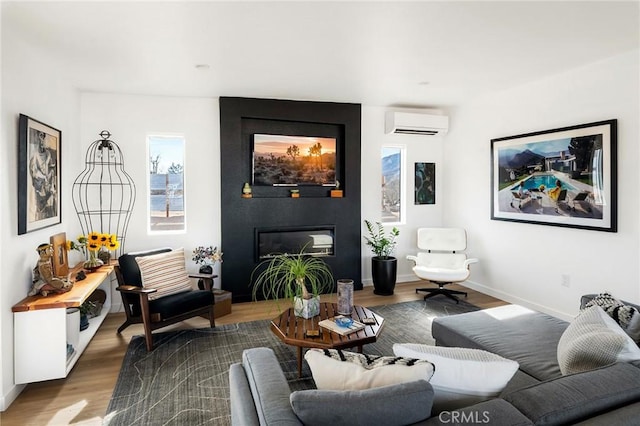 67712 Whitmore Rd Unit 29, Palms, CA 92277 - living area with an AC wall unit, wood finished floors, and a large fireplace