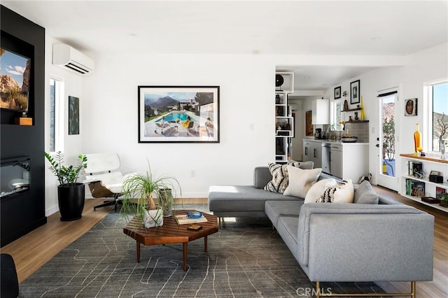 67712 Whitmore Rd Unit 29, Palms, CA 92277 - living area with an AC wall unit and dark wood-style flooring