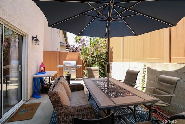 13421 Hubbard St Unit 119, Sylmar, CA 91342 - view of patio / terrace with a grill and outdoor dining space