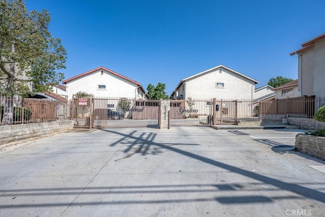 13421 Hubbard St Unit 119, Sylmar, CA 91342 - rear view of house featuring a gate and stucco siding